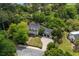 Aerial shot showcasing the beautiful two-story home with lush landscaping and a curved driveway at 9340 Lake Dr., Myrtle Beach, SC 29572