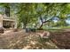 Brick patio area with outdoor seating, fire pit, and views of the lake and golf course beyond the fenced yard at 9340 Lake Dr., Myrtle Beach, SC 29572