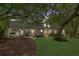 Expansive backyard view of the rear exterior featuring a firepit, entertaining area, and lush lawn at 9340 Lake Dr., Myrtle Beach, SC 29572