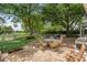 Backyard patio with brick pavers and outdoor dining under mature trees at 9340 Lake Dr., Myrtle Beach, SC 29572