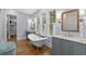 Bright bathroom featuring a soaking tub, double sinks, and large windows for natural light at 9340 Lake Dr., Myrtle Beach, SC 29572