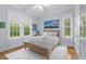 Bedroom with hardwood floors, a ceiling fan, and multiple windows at 9340 Lake Dr., Myrtle Beach, SC 29572