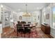 Bright dining room featuring a round table, area rug, piano, and windows at 9340 Lake Dr., Myrtle Beach, SC 29572