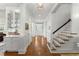 Bright hallway featuring hardwood floors, white trim, staircase and paneled walls at 9340 Lake Dr., Myrtle Beach, SC 29572