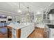 Open kitchen and living space featuring a large island with marble countertops and hardwood floors at 9340 Lake Dr., Myrtle Beach, SC 29572