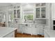 Kitchen featuring a white farmhouse sink, marble countertops, and stainless steel appliances at 9340 Lake Dr., Myrtle Beach, SC 29572