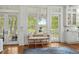 Cozy living space with a rattan bench and large windows overlooking the backyard at 9340 Lake Dr., Myrtle Beach, SC 29572