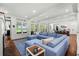 Bright and airy living room with comfortable blue sectional and views of the outdoors at 9340 Lake Dr., Myrtle Beach, SC 29572