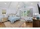 Calming main bedroom featuring neutral colors, multiple windows, and a chandelier at 9340 Lake Dr., Myrtle Beach, SC 29572