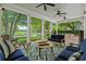 Covered porch with wood flooring, ceiling fans, plush seating, and views of the lawn at 9340 Lake Dr., Myrtle Beach, SC 29572