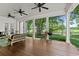 Covered porch with wood flooring, ceiling fans, seating, and golf course views at 9340 Lake Dr., Myrtle Beach, SC 29572