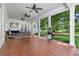 Covered porch with wood flooring, ceiling fans, seating, and lawn views at 9340 Lake Dr., Myrtle Beach, SC 29572