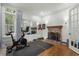 Workout room with hardwood floors, a fireplace, and large windows at 9340 Lake Dr., Myrtle Beach, SC 29572
