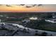 Aerial view overlooking a golf course, waterway, and neighborhood homes during a beautiful sunset at 9500 Shore Dr. # 17B, Myrtle Beach, SC 29572