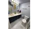 Well lit bathroom with double sink vanity, decorative mirrors, and toilet at 9500 Shore Dr. # 17B, Myrtle Beach, SC 29572