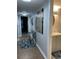 Hallway leading to partial bathroom with cabinet sink and patterned rug at 9500 Shore Dr. # 17B, Myrtle Beach, SC 29572