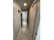 Hallway with tile flooring leading to a bathroom with a toilet and closet at 9500 Shore Dr. # 17B, Myrtle Beach, SC 29572
