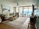 Cozy living room with large windows and view to the balcony overlooking the ocean at 9500 Shore Dr. # 17B, Myrtle Beach, SC 29572