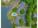 Stunning aerial view of buildings and pool overlooking a lake surrounded by lush greenery and parking at 9551 Edgerton Dr. # C-6, Myrtle Beach, SC 29572