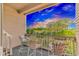 Enjoy the serene water views from this condo's private balcony with comfortable seating and decorative flower boxes at 9551 Edgerton Dr. # C-6, Myrtle Beach, SC 29572