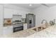 Bright kitchen with modern appliances, granite counters, white cabinets, and subway tile backsplash at 9551 Edgerton Dr. # C-6, Myrtle Beach, SC 29572
