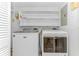 Functional laundry room with modern Maytag washer and dryer, plus overhead storage at 9551 Edgerton Dr. # C-6, Myrtle Beach, SC 29572
