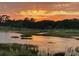 The sun sets over the waterway and golf course in this scenic view at 9551 Edgerton Dr. # C-6, Myrtle Beach, SC 29572