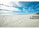 White sandy beach under a beautiful blue sky filled with clouds at 9621 Shore Dr. # F-117, Myrtle Beach, SC 29572