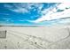 Beautiful sandy beach with tire tracks in the sand with a fishing pier in the distance at 9621 Shore Dr. # F-117, Myrtle Beach, SC 29572