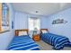 Cozy bedroom with twin beds, soft carpet, and a bright window at 9621 Shore Dr. # F-117, Myrtle Beach, SC 29572