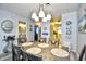 Charming dining area with a modern light fixture, beach-themed decor, and views of the kitchen at 9621 Shore Dr. # F-117, Myrtle Beach, SC 29572