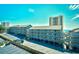 Multi-level condo complex with parking and staircases, offering beach views and a city highrise in the background at 9621 Shore Dr. # F-117, Myrtle Beach, SC 29572