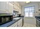 Bright kitchen with white cabinets, blue countertops and stainless steel appliances at 9621 Shore Dr. # F-117, Myrtle Beach, SC 29572