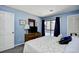 Comfortable main bedroom featuring balcony access, TV, and tasteful decorations at 9621 Shore Dr. # F-117, Myrtle Beach, SC 29572