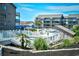 Community pool surrounded by landscaping and condos with blue roofs in the background at 9621 Shore Dr. # F-117, Myrtle Beach, SC 29572