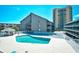 Inviting pool area with lounge chairs and a gazebo, perfect for relaxation at 9621 Shore Dr. # F-117, Myrtle Beach, SC 29572