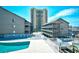 Stunning outdoor pool and sundeck area with multiple buildings and a high rise tower in the background at 9621 Shore Dr. # F-117, Myrtle Beach, SC 29572