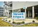 The Shipwatch Pointe 1 sign is surrounded by landscaped gravel and sits below the raised condos at 9621 Shore Dr. # F-117, Myrtle Beach, SC 29572