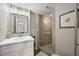 Bright bathroom with a modern vanity, framed mirror, and a glass-enclosed shower at 9661 Shore Dr. # B-3, Myrtle Beach, SC 29572