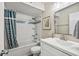 Clean bathroom featuring a white vanity, bathtub with shower, and blue patterned curtain at 9661 Shore Dr. # B-3, Myrtle Beach, SC 29572
