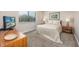 Bright bedroom featuring neutral tones, a comfortable bed, and ample natural light from a window with blinds at 9661 Shore Dr. # B-3, Myrtle Beach, SC 29572