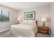 Bright bedroom featuring neutral tones, a comfortable bed, and ample natural light from a window with blinds at 9661 Shore Dr. # B-3, Myrtle Beach, SC 29572