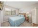 Cozy bedroom with a blue bedspread, woven headboard, and ample natural light from a window at 9661 Shore Dr. # B-3, Myrtle Beach, SC 29572