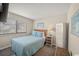 Cozy bedroom featuring a queen bed with blue bedding and a light-filled window at 9661 Shore Dr. # B-3, Myrtle Beach, SC 29572