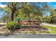 Arcadian Shores Golf Club entrance sign amidst lush greenery and a tree-lined street at 9661 Shore Dr. # B-3, Myrtle Beach, SC 29572