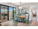 Cozy dining area featuring a table with blue chairs and a large window with outdoor views at 9661 Shore Dr. # B-3, Myrtle Beach, SC 29572