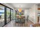 Bright dining room with a dining table that leads to a balcony with plenty of sunlight and an open kitchen area at 9661 Shore Dr. # B-3, Myrtle Beach, SC 29572