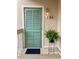 Charming entrance showcasing a shuttered door, fern, and outdoor lighting, creating a welcoming entryway at 9661 Shore Dr. # B-3, Myrtle Beach, SC 29572