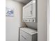 Compact laundry room with a stacked washer and dryer and neutral wall at 9661 Shore Dr. # B-3, Myrtle Beach, SC 29572