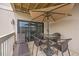 Cozy patio with table, chairs, lounge and relaxing umbrella at 9661 Shore Dr. # B-3, Myrtle Beach, SC 29572